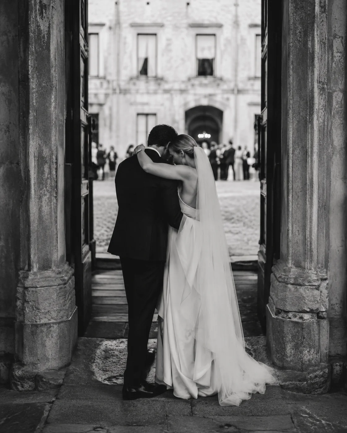 Newlyweds embracing in a historic doorway